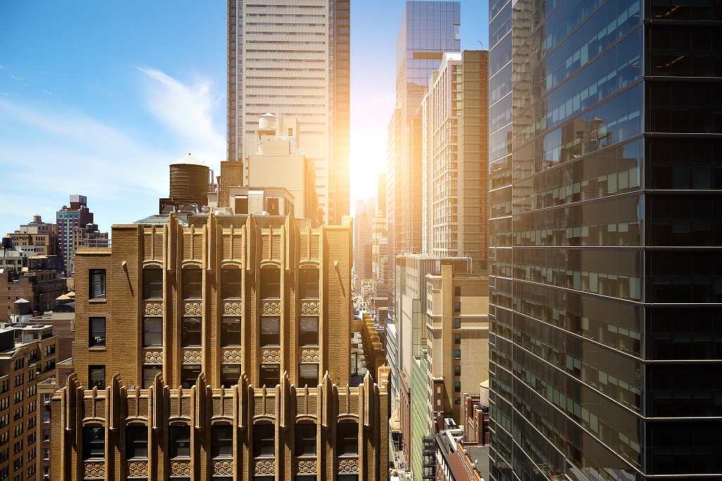 shutterstock view of sunrise between manhattan high rise buildings