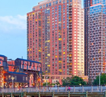 image of the long island city sign with modern hirise architecture in the background