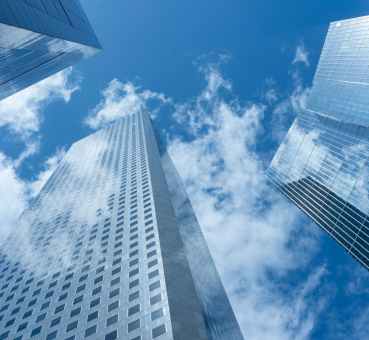 vertical view of modern office buildings facing up from the ground level