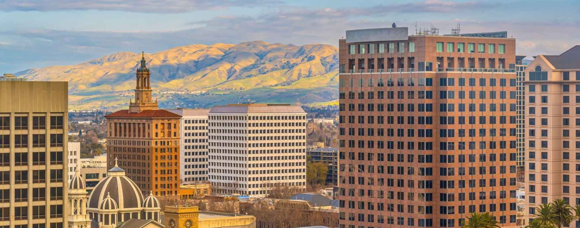 san diego central business district highrise skyline with mountains in the background