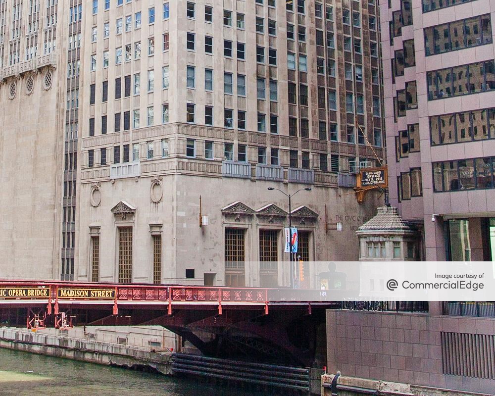 View from the river of the ground level exterior of the Civic Opera Building at 20 North Wacker Drive, in the Chicago Loop