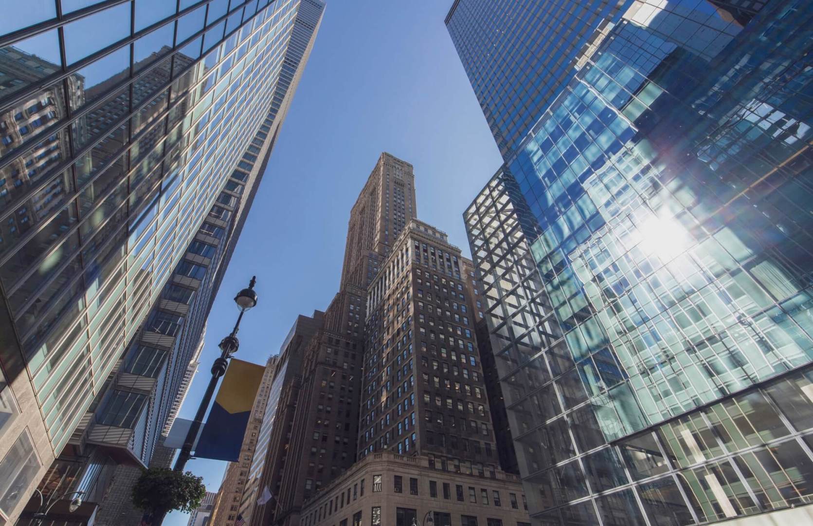 street level view of one grand central place tower, which combines manhattan retail space with office, surrounded by other similar commercial property high-rises in the vicinity
