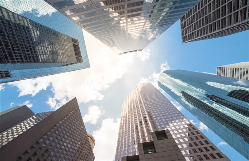ground-up view of glass facade office skyscrapers