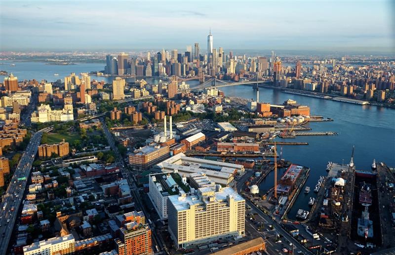 aerial landscape view of brooklyn navy yard with Manhattan skyline in the distance