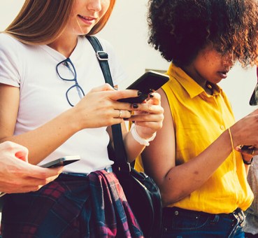 Image of young people, Gen Z, using their smartphones