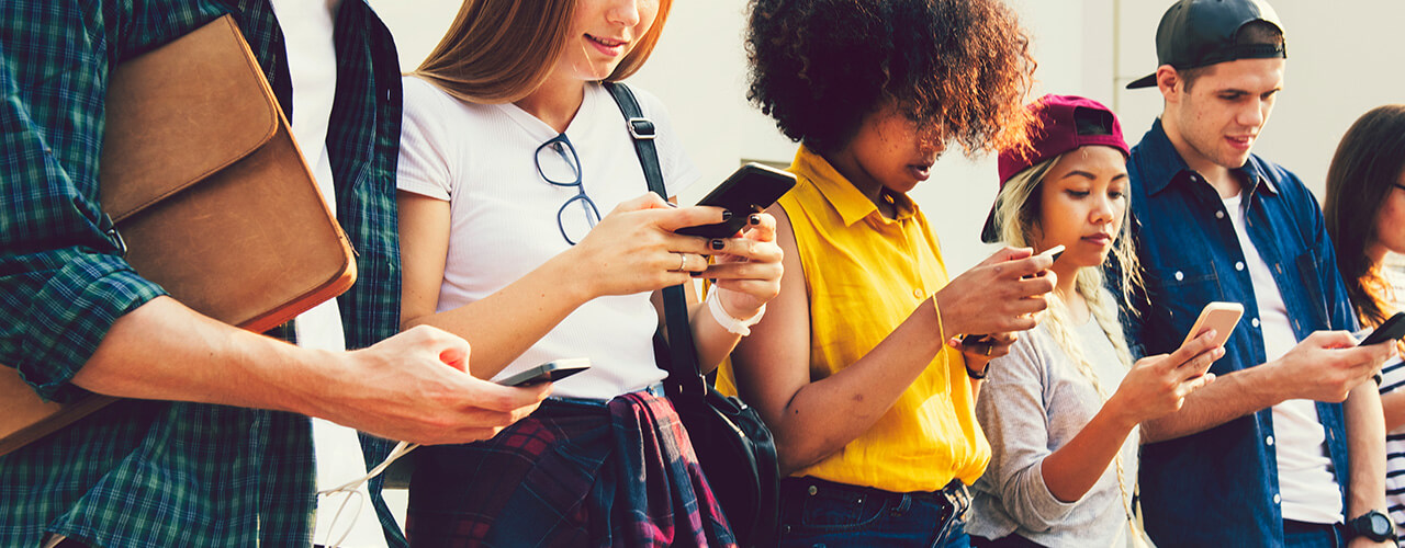 Image of young people, Gen Z, using their smartphones