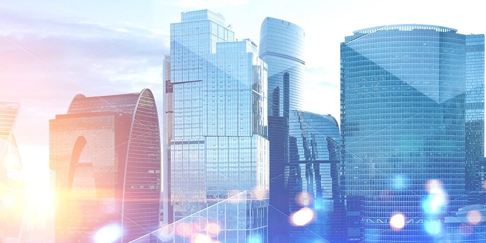 Panoramic view of modern cityscape with skyscrapers and glass towers with double exposure of triangular pattern for expert insights with joe killinger