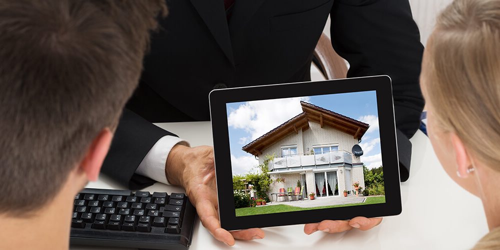 broker showing house to couple