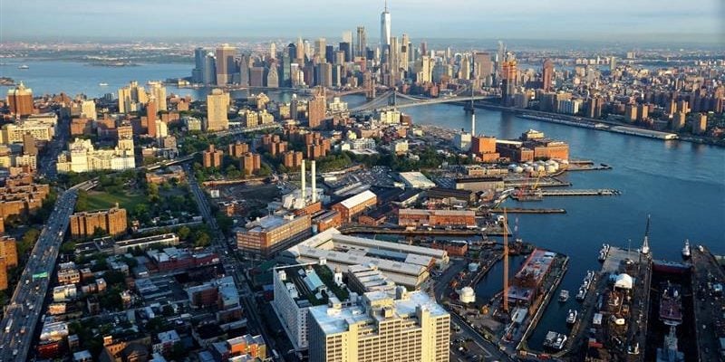 aerial landscape view of brooklyn navy yard with Manhattan skyline in the distance