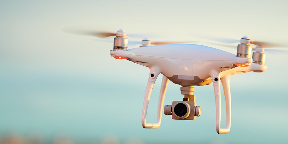 Image of flying commercial drone equipped with camera