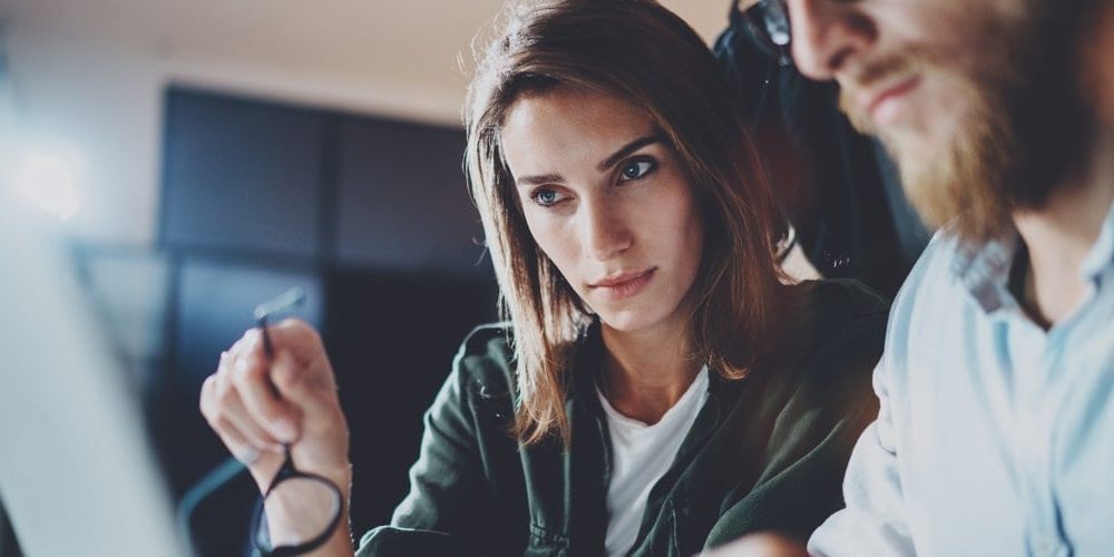 A businesswoman and businessman discussing a project - featured image