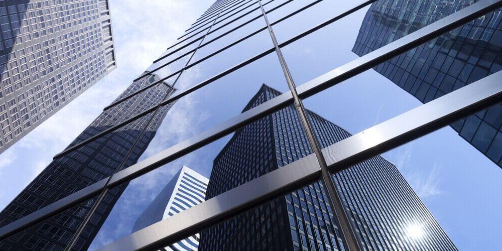 Office buildings reflecting in glass windows