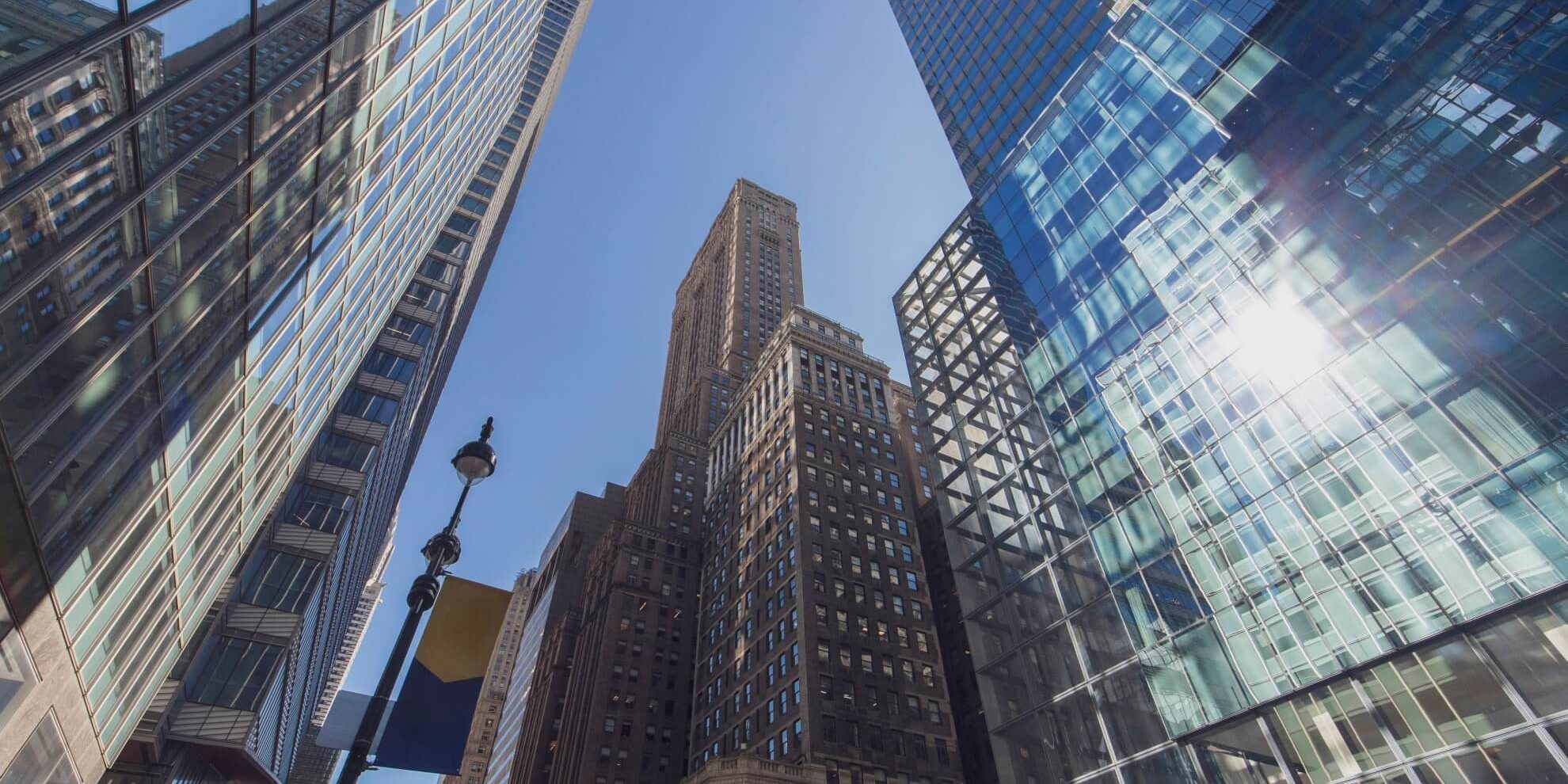 street level view of one grand central place tower, which combines manhattan retail space with office, surrounded by other similar commercial property high-rises in the vicinity