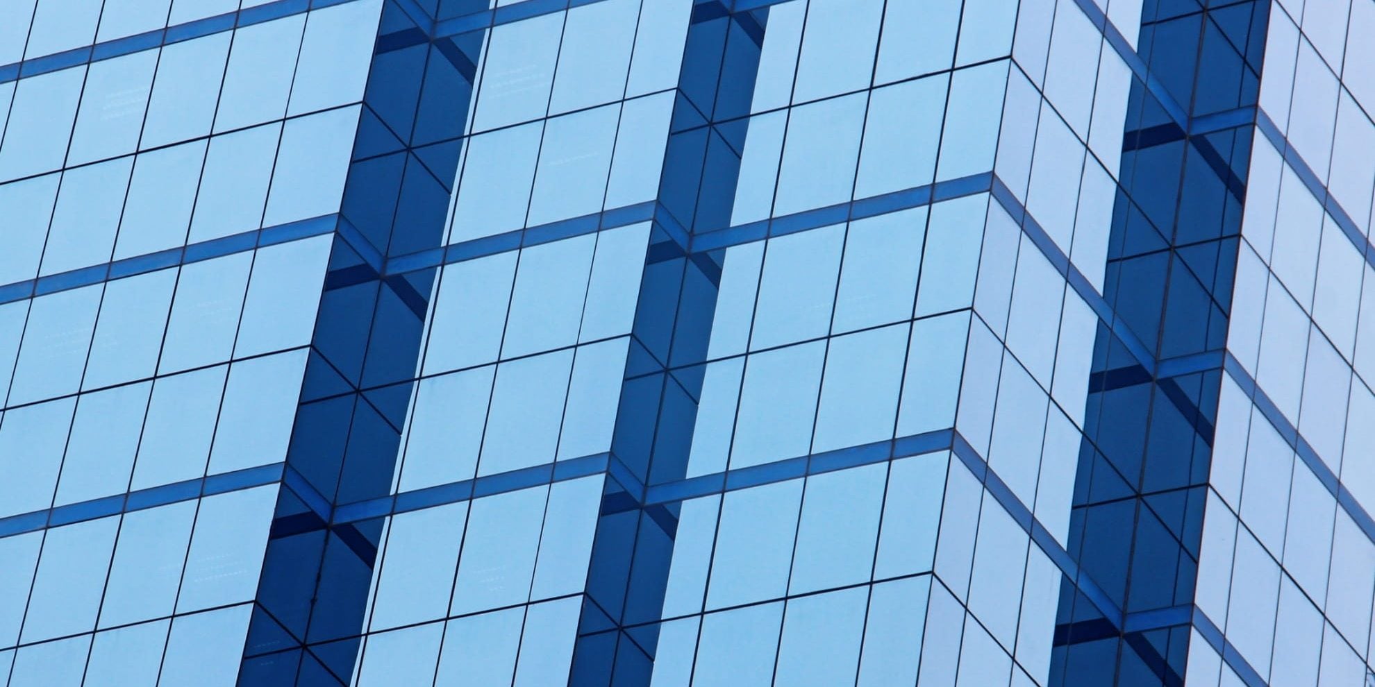 modern glass office building facade for national office report october 2025