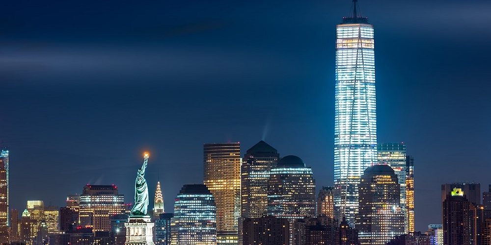 Night view over Lower Manhattan, with One World Trade Center and The Statue of Liberty