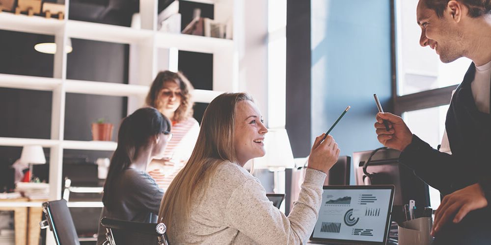 Young business team working together in bright loft space