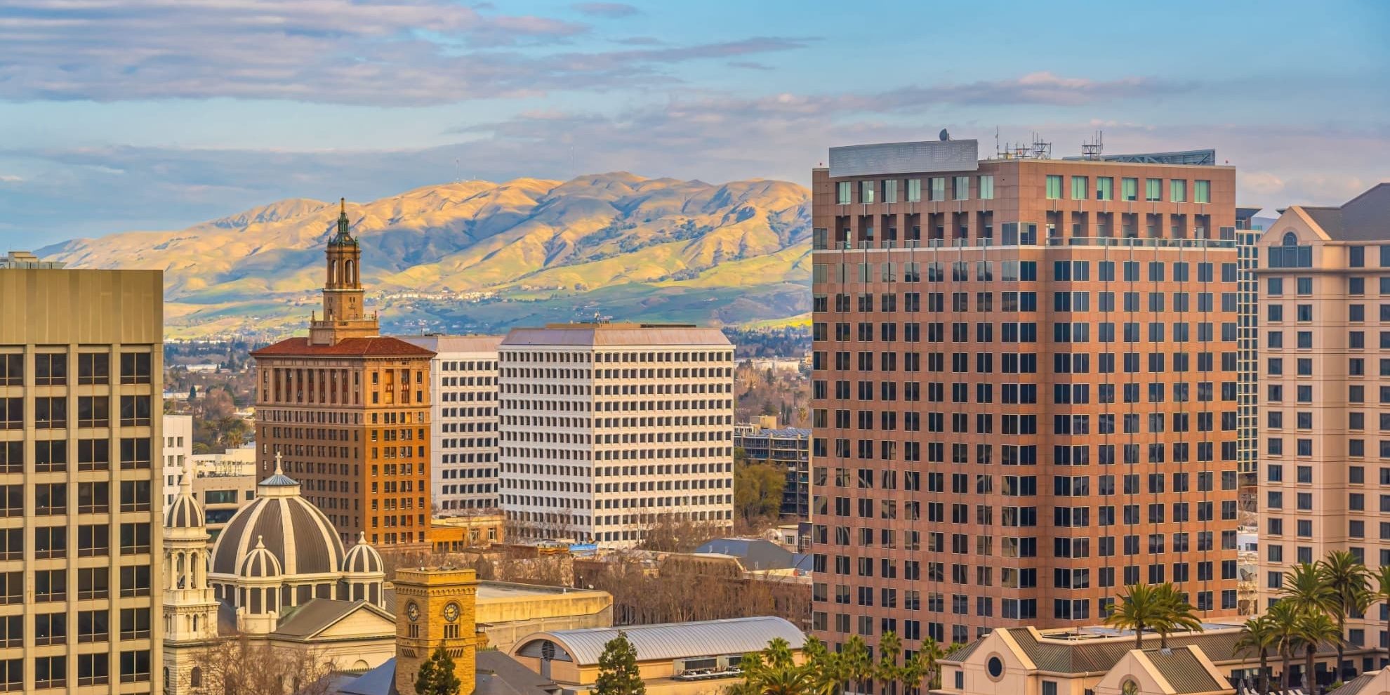 san diego central business district highrise skyline with mountains in the background