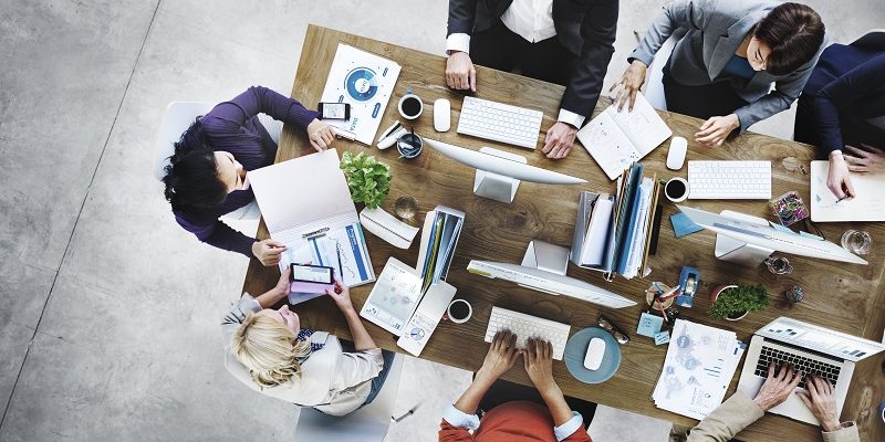 group of office professionals sharing small space in small office