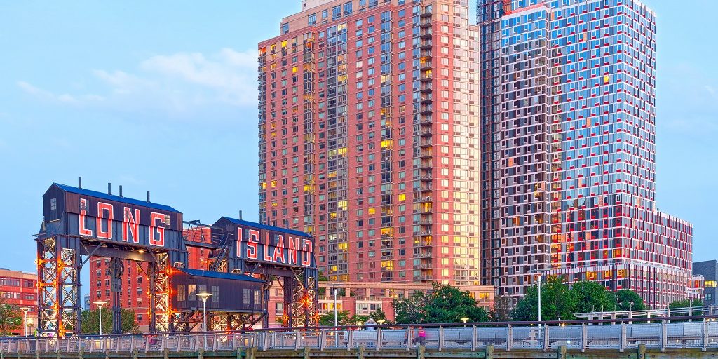 image of the long island city sign with modern hirise architecture in the background