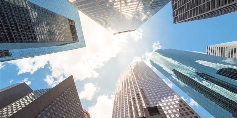 ground-up view of glass facade office skyscrapers