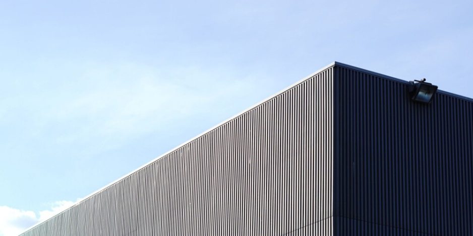 partial view of the outside roof line and corner of a warehouse building