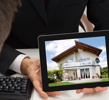 broker showing house to couple