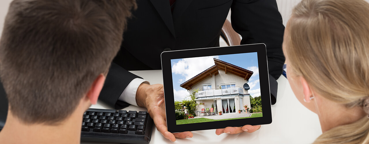 broker showing house to couple