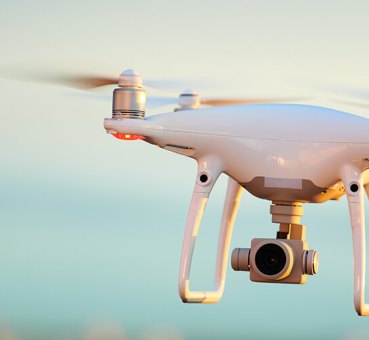 Image of flying commercial drone equipped with camera
