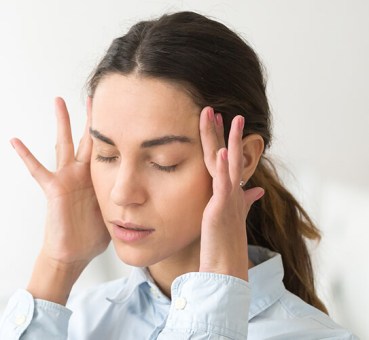 Young woman frustrated by her coworkers' office behaviors