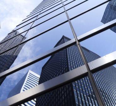 Office buildings reflecting in glass windows