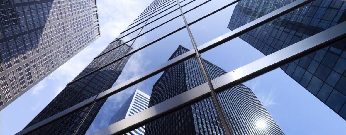 Office buildings reflecting in glass windows