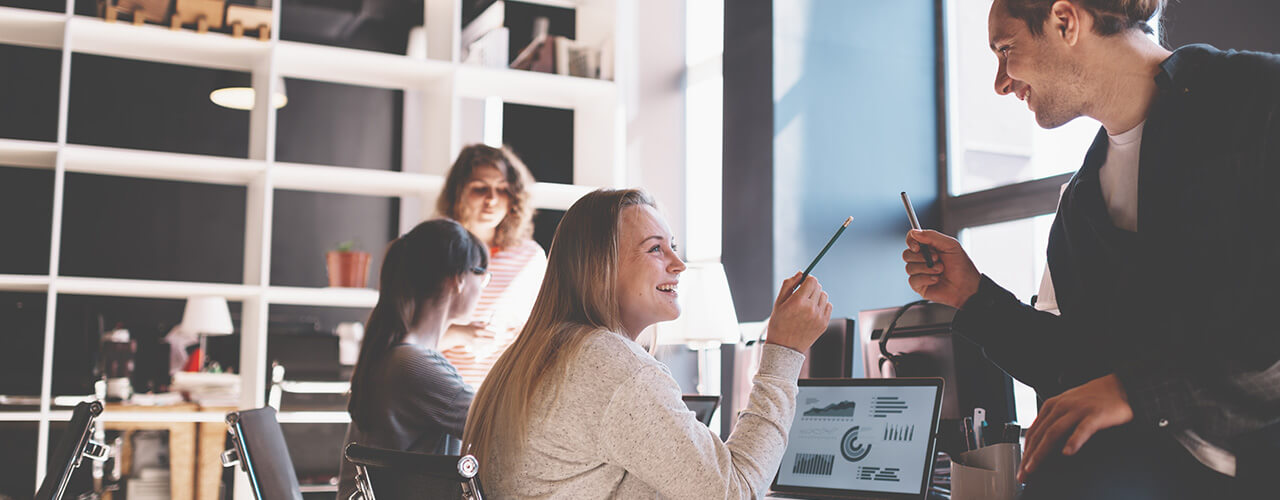Young business team working together in bright loft space