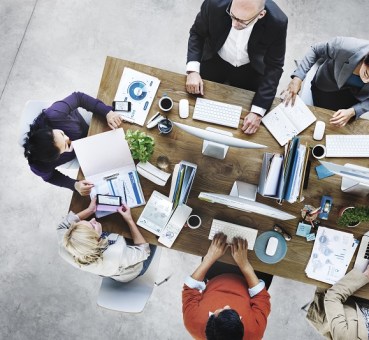 group of office professionals sharing small space in small office