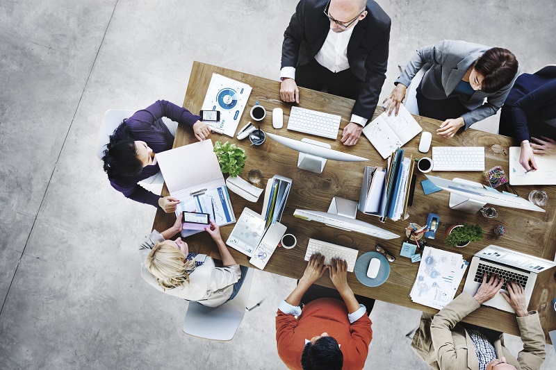 group of office professionals sharing small space in small office