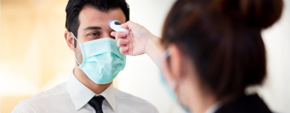 man having his temperature checked at the entrance