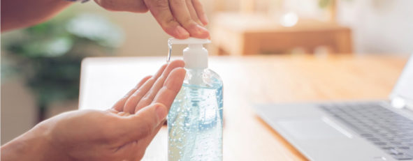 employee using hand sanitizer at the office